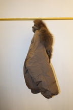 Brown fur puffer coat with a hood on a white background