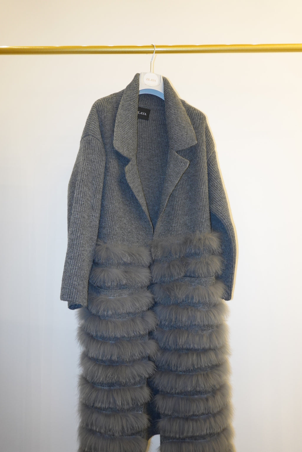 Gray textured coat with fur  on a white background