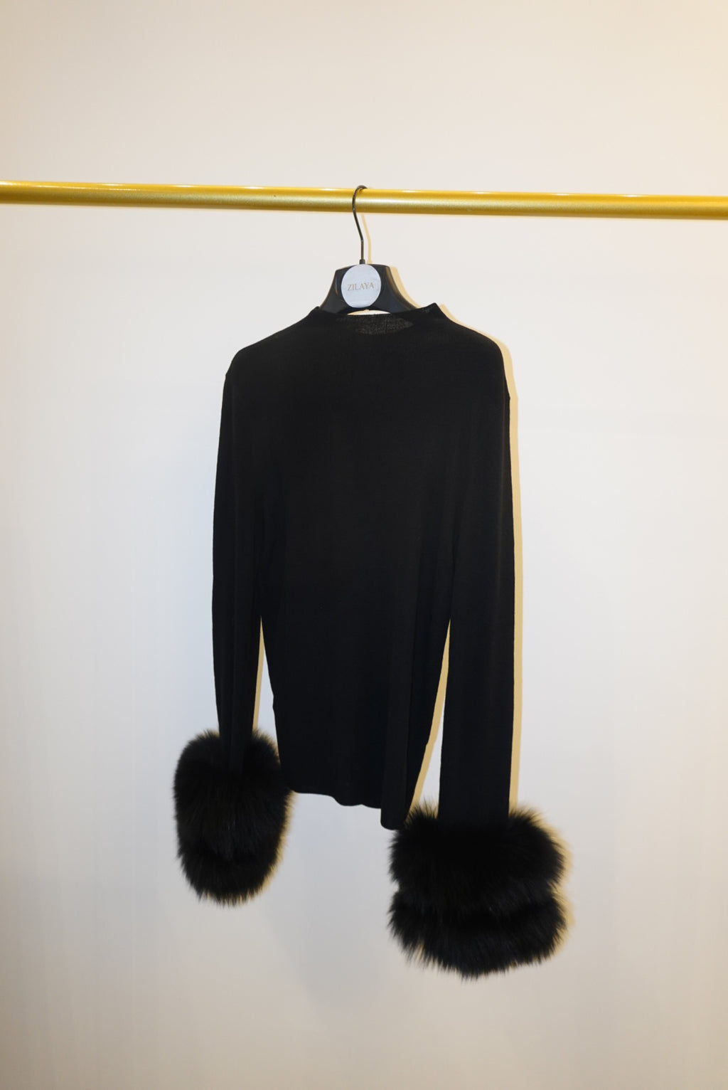 Black top with detachable fur cuffs