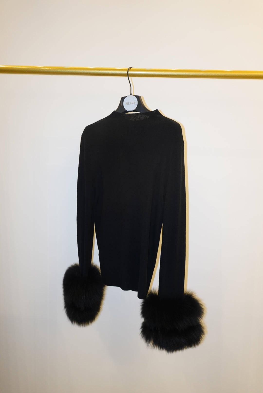 Black top with detachable fur cuffs