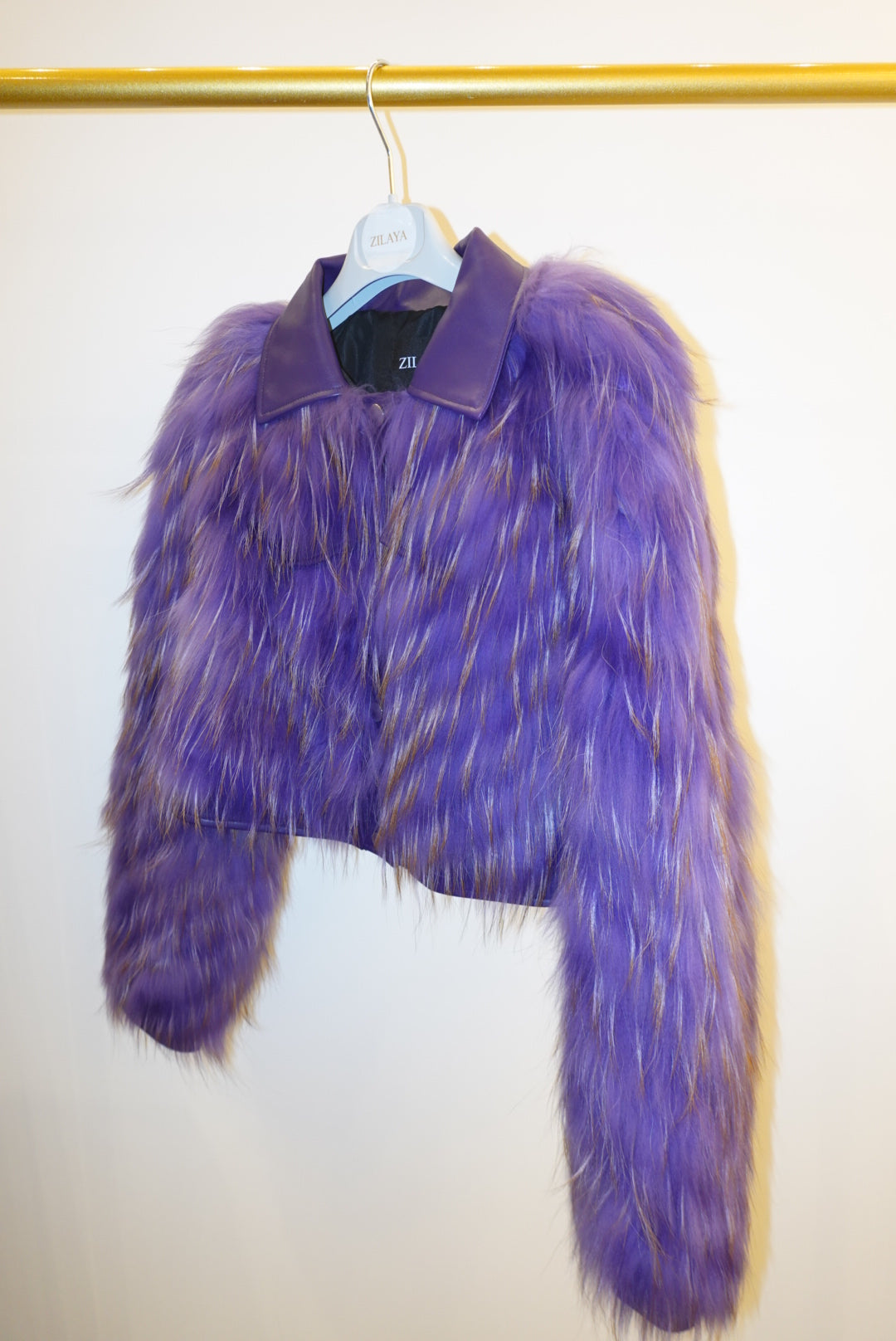 Purple fur jacket on a white background