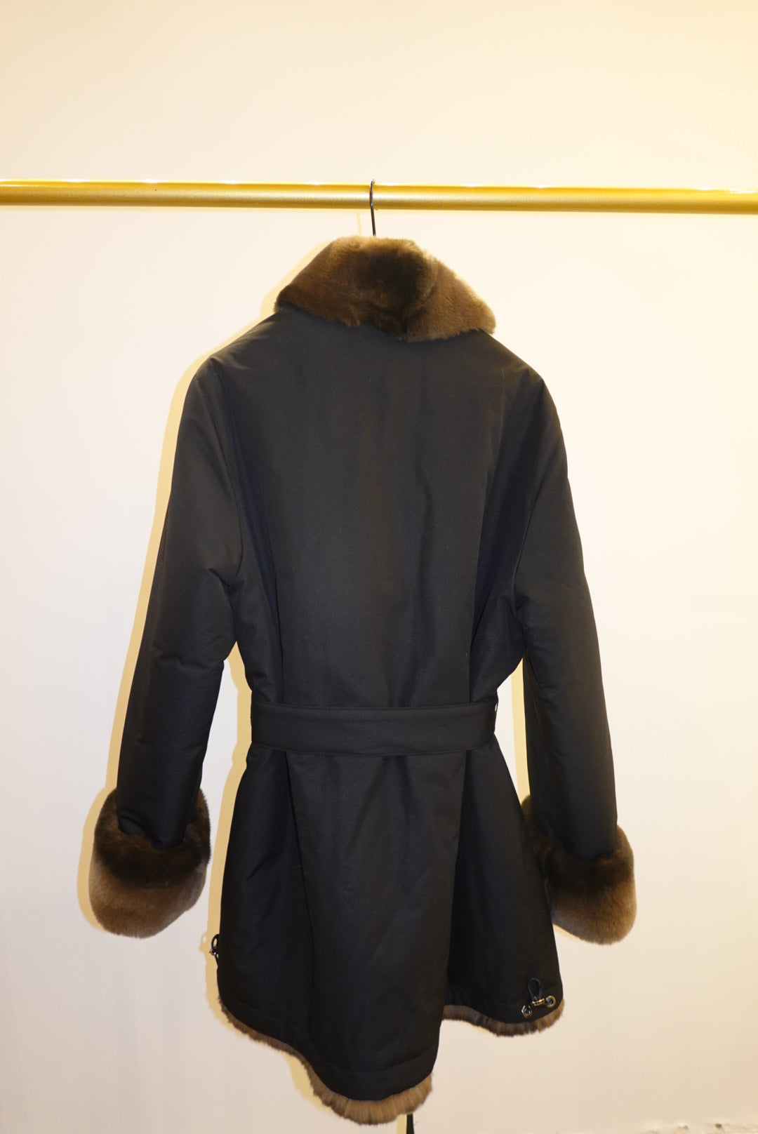 Dark blue coat with fur trim on a white background
