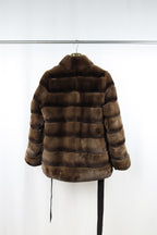 reversible fur coat against a white background